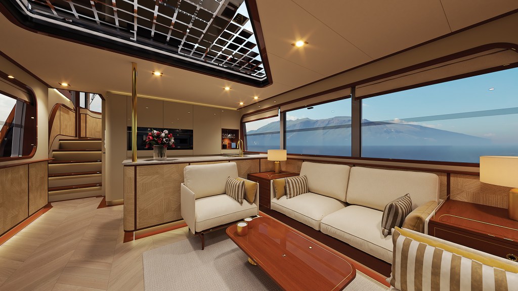 An interior rendering of a warm, luxurious yacht salon and galley area illuminated by soft ambient lighting. On the right, a long cream-colored sofa and matching armchair feature striped accent pillows, arranged around a polished wood coffee table. Large panoramic windows offer a stunning view of a calm blue ocean and distant mountains. In the background, a modern galley kitchen features light wood cabinets and a marble countertop decorated with a bouquet of red flowers. On the left, a short flight of wood-paneled stairs leads upward, while a large, unique glass skylight section in the ceiling reveals grid-patterned solar panels overhead.