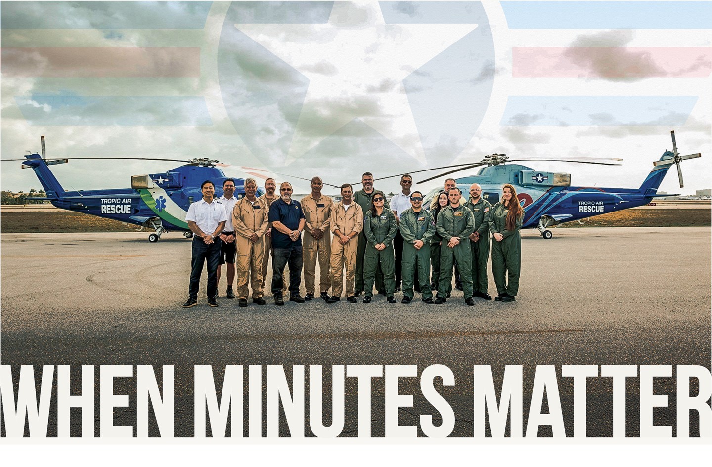 A wide shot of the Tropic Air Rescue team standing together on an airport tarmac between two large blue rescue helicopters. The flight crew, pilots, and medical personnel wear a mix of green flight suits, tan jumpsuits, and polo shirts. In the background, a cloudy sky features a large, semi-transparent watermark logo of a star with wings. Bold, white capital letters overlay the bottom of the image, reading "WHEN MINUTES MATTER."