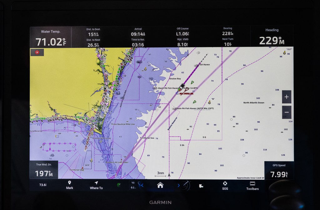 feat_AIS A Garmin marine chartplotter display screen showing a digital nautical map with AIS vessel tracking, route waypoints, and navigation data overlay.
