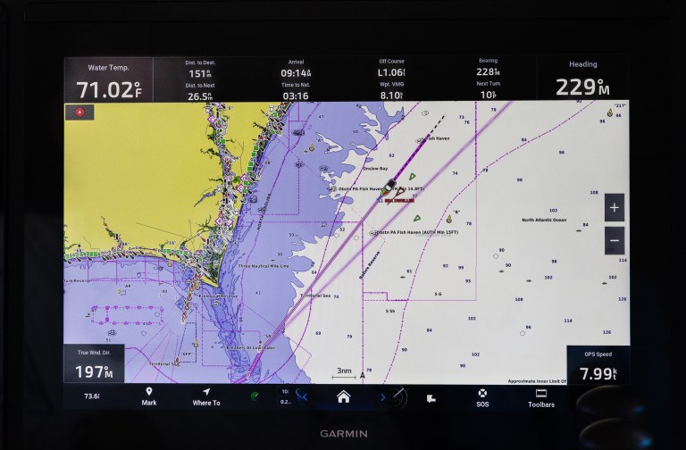feat_AIS A Garmin marine chartplotter display screen showing a digital nautical map with AIS vessel tracking, route waypoints, and navigation data overlay.