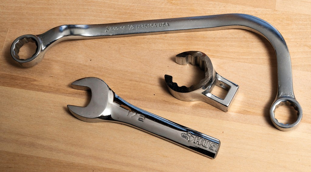 Specialty marine tools including a curved Snap-on Detroit Diesel fuel pump wrench, a crowfoot wrench, and a stubby open-end wrench.