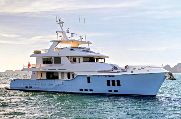 feat-Nordhavn_100 Profile view of a light blue Nordhavn 100 expedition yacht underway on open water.