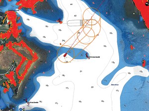 Furuno NavNet TZtouchXL display showing AI avoidance routing with dynamic safety zone overlays on a marine bathymetric chart.