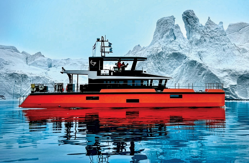 feat_Tangerine_Dream Side profile of the bright orange and black custom expedition yacht Vanguard floating in calm blue arctic waters, perfectly reflected on the surface against a backdrop of massive white and ice-blue glaciers under a pale blue sky.