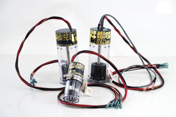 Three Ultra Safety Systems magnetic float switches, including Ultra Mini and Junior models, shown with wiring and adjustable hose clamp mounting hardware.
